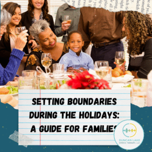 A multigenerational family sits and stands around a festive holiday table, smiling and talking together. A young boy sits at the center, smiling toward the camera while an older woman hugs him. Plates of food and glasses are on the table. Over the bottom half of the image is a graphic of lined notebook paper with the text “Setting Boundaries During the Holidays: A Guide for Families.” The Duncan Lake Therapy Collective logo appears in the lower right corner.